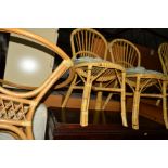 A BAMBOO CIRCULAR GLASS TOPPED CONSERVATORY TABLE, four chairs and a similar nest of three tables (