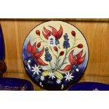 A MOORCROFT POTTERY LIMITED EDITION 2001 PLATE, florally decorated, diameter 22.5cm
