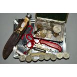A TIN OF COINS, POCKET KNIVES AND WHISTLES