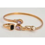 A 9CT GOLD AMETHYST AND DIAMOND TORQUE BANGLE AND TWO 9CT GOLD RINGS, the bangle of cross over