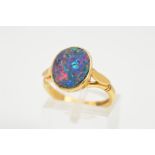 AN 18CT GOLD OPAL RING, designed as an oval opal doublet in a collet mount, to the plain polish