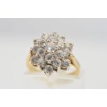 A 9CT GOLD CLUSTER RING, designed with nineteen circular cubic zirconia stones in a tiered