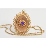 A 9CT GOLD AMETHYST PENDANT AND CHAIN, the pendant of oval outline with central circular amethyst on