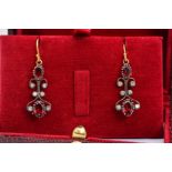 A PAIR OF GARNET AND DIAMOND EARRINGS, each of scrolling wire design with brilliant cut diamond