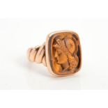 A LATE VICTORIAN TIGER'E EYE SIGNET RING, the rectangular tiger's eye panel carved to depict a