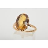 A CITRINE RING, designed as an oval shape citrine, within a six claw setting, stamped 9ct, ring size