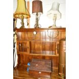 AN EARLY 20TH CENTURY OAK SLOPPED STORAGE BOX, together with three table lamps (4)