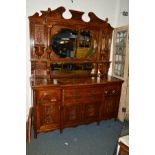 AN EARLY 20TH CENTURY ART NOUVEAU OAK MIRROR BACK SIDEBOARD, the top with a swan neck pediment,