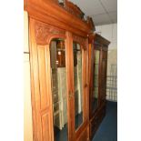 AN EDWARDIAN WALNUT DOUBLE MIRROR DOOR WARDROBE above a single drawer, width 131cm x depth 51cm x