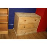 A VICTORIAN STRIPPED PINE CHEST OF THREE LONG DRAWERS, with turned handles (two missing)