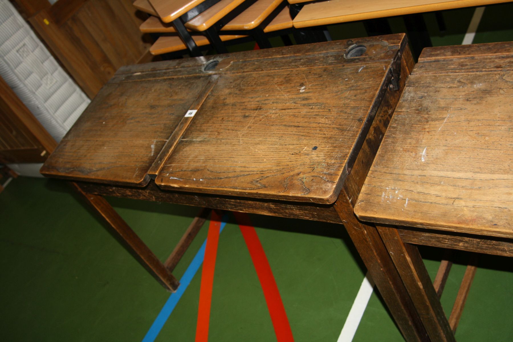 A VINTAGE DOUBLE SCHOOL DESK, with oak top, two lift up lids, two copper sliding ink well cover