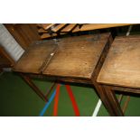A VINTAGE DOUBLE SCHOOL DESK, with oak top, two lift up lids, two copper sliding ink well cover