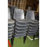 EIGHTEEN GREY PLASTIC STACKING CHAIRS, with black tubular metal legs (s.d)