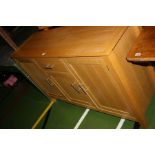 A MODERN OAK SIDEBOARD, with three cupboards and one drawer 140x44x86cm high