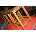 THREE MODERN BEECHWOOD LABORATORY STOOLS, with hand hold in centre of the seat, 51cm high (s.d)