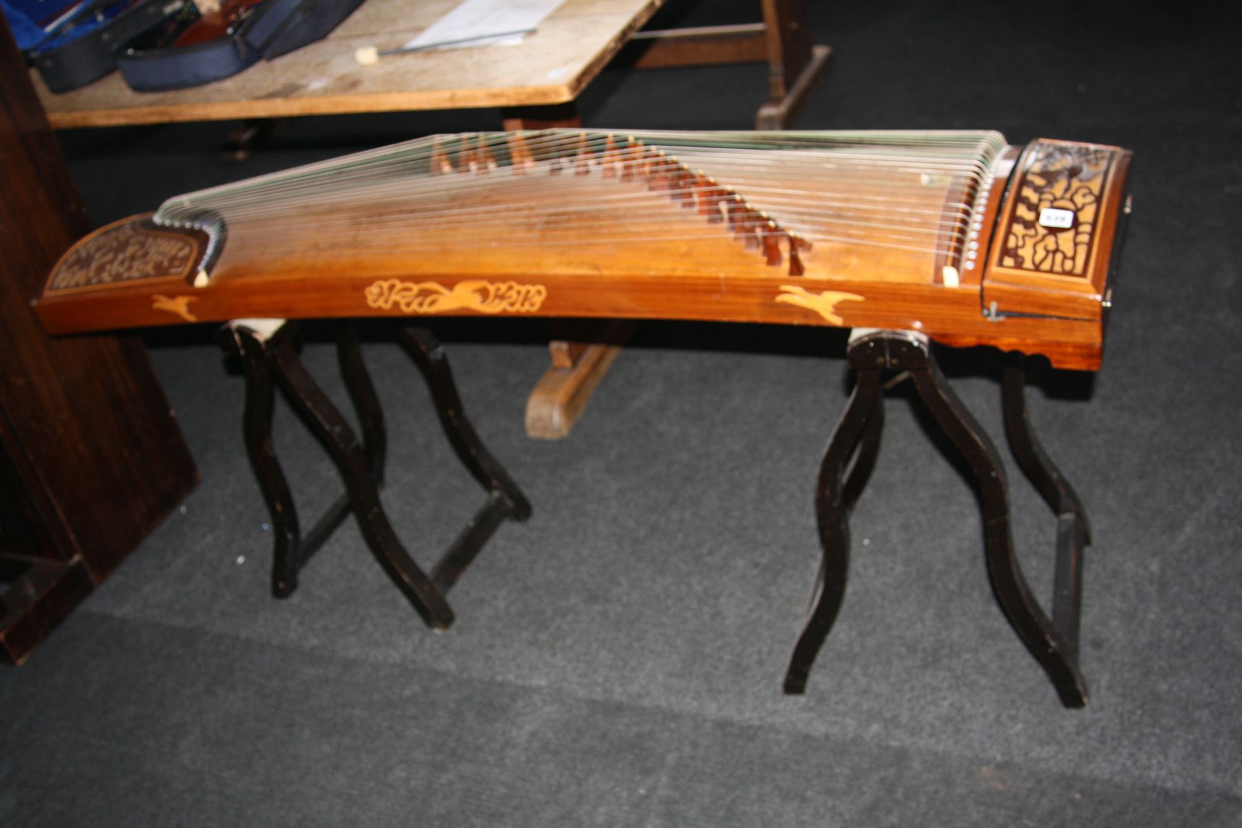 A CHINESE GUZHENG, plucked 21 string instrument with bird and foliage fretwork panels to either