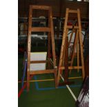 THREE VINTAGE FOLDING ARTISTS EASELS, a T square and a table top drawing board two made from pine