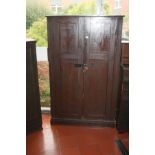 A STAINED PINE EDWARDIAN TWO DOOR CUPBOARD, with three static shelves to interior and a more