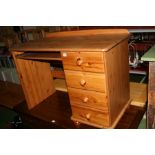 A MODERN PINE DESK WITH FOUR DRAWERS AND A KEYBOARD SLIDE, 109x58x74cm high (s.d)