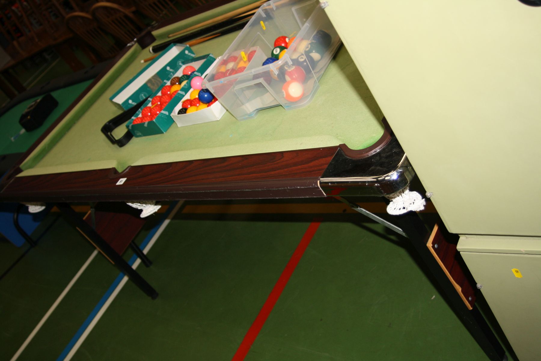 A FOLDING POOL TABLE, with various balls, cues and accessories 188x109x82cm high (s.d)