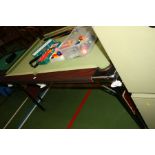 A FOLDING POOL TABLE, with various balls, cues and accessories 188x109x82cm high (s.d)