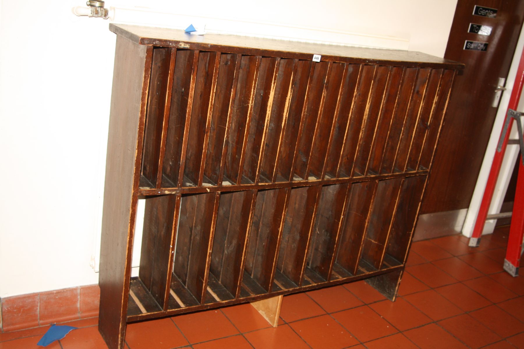 A VICTORIAN PINE MUSIC RACK, with eighteen apertures on the top row and nine on the bottom (adapted)