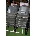 TWENTY FOUR GREY PLASTIC STACKING CHAIRS, with black tubular metal legs (s.d)