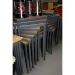 TWELVE MODERN STACKING SQUARE CLASSROOM TABLES, with beech effect tops over a tubular metal base (