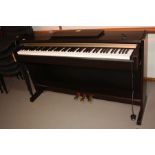 A YAMAHA CLAVINOVA CL-220 ELECTRONIC PIANO, with a rosewood effect finish 135cm wide