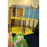 FOUR YELLOW AND BLACK CHILDS TABLES, with angled ends and a matching rectangular table,