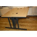 TWO OFFICE TABLES, with beechwood effect tops over grey metal legs with two cable apertures and