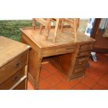 AN EDWARDIAN ROLL TOP DESK BASE, (no top) in walnut with one long and four short graduating