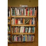 AN OAK VENEERED DOUBLE SIDED ROLLING BOOKCASE, with eight adjustable shelves and wheels,