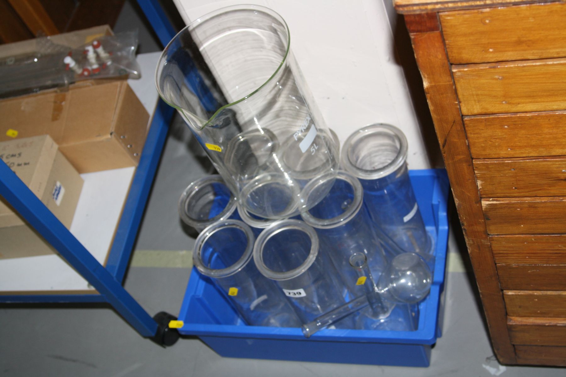 A BOX OF GLASS FLASKS, beakers and cylinders, for chemistry experiments