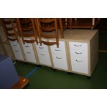 FIVE MODERN MAPLE EFFECT AND WHITE BEDSIDE DRAWERS, with three graduating drawers, stainless steel