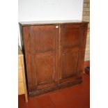A STAINED PINE EDWARDIAN TWO DOOR CUPBOARD, with two full and one half shelves to the interior