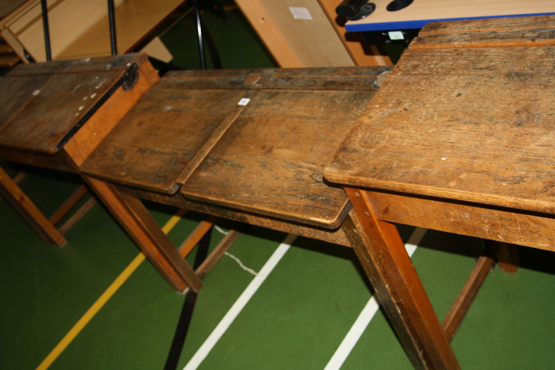 A VINTAGE DOUBLE SCHOOL DESK, with oak top, two lift up lids, two copper sliding ink well cover