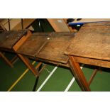 A VINTAGE DOUBLE SCHOOL DESK, with oak top, two lift up lids, two copper sliding ink well cover