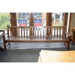 A TEAK SLATTED GARDEN BENCH, 253cm long with a presentation plaque dated 1969