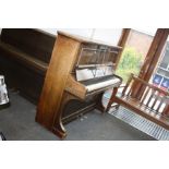 AN ELYSIAN UPRIGHT PIANO, with lots of scratched signatures all over the mahogany case (s.d)
