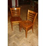 A SET OF EIGHT MODERN STAINED BEECH DINING CHAIRS, with shaped laminated seats