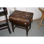 AN EDWARDIAN MAHOGANY CANTILEVER PIANO STOOL, with original brown leather buttoned seat covering (