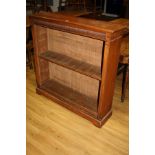 AN EDWARDIAN MAHOGANY BOOKCASE, with three adjustable shelves (some supports missing) with reeded