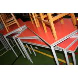 EIGHT RED CLASSROOM TABLES, with tubular metal legs, melamine top and rubber edges 120x60x70cm
