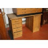 A VICTORIAN OAK KNEE HOLE DESK, with four drawers to the left and cupboard to the right with locks