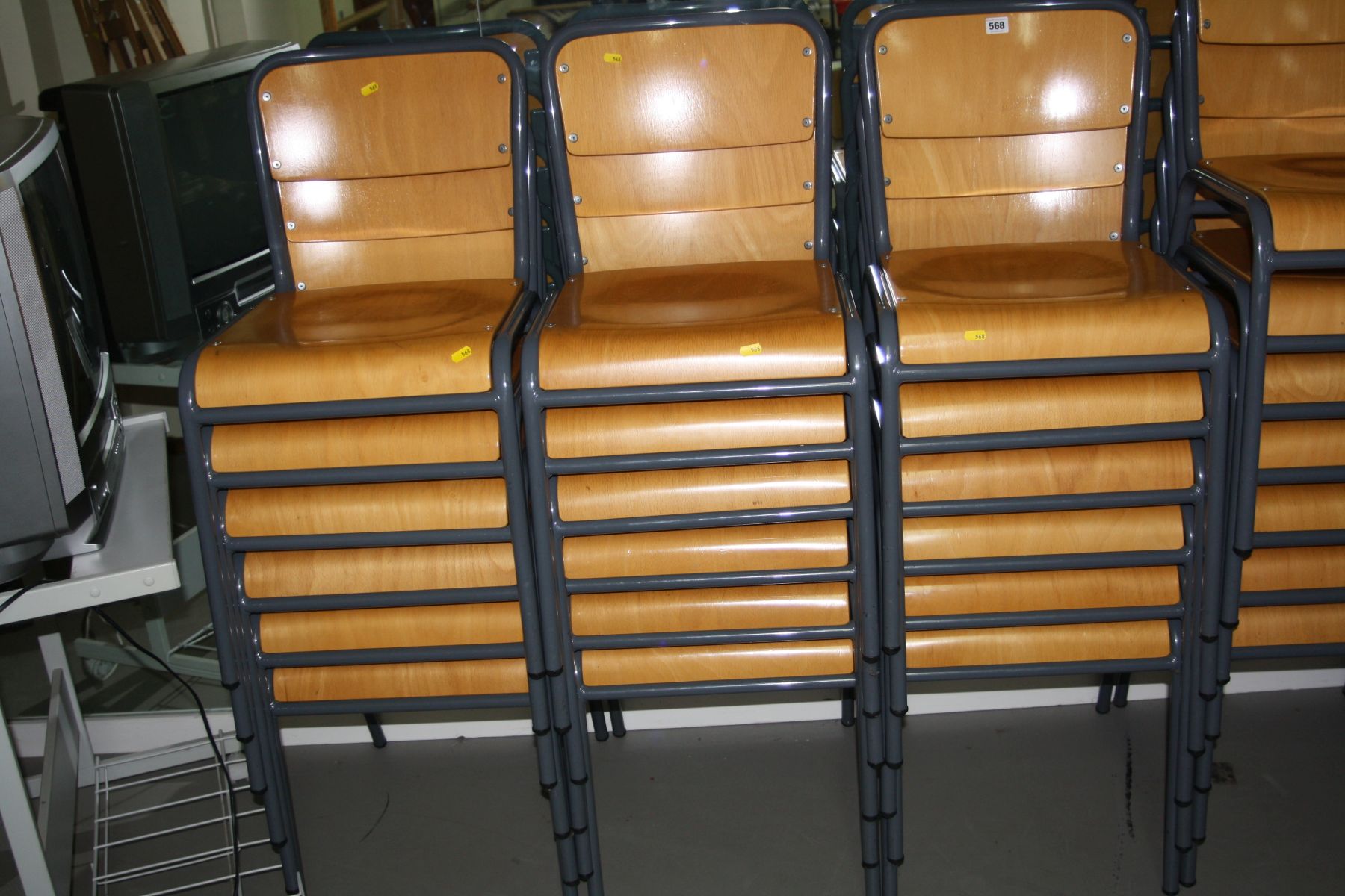 EIGHTEEN STACKING CLASSROOM CHAIRS, with bentwood seats and backs over a grey tubular metal frame