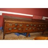 A GEORGIAN OAK DRESSER BASE WITH SIX DRAWERS, shaped skirt and legs with six vertically graduated