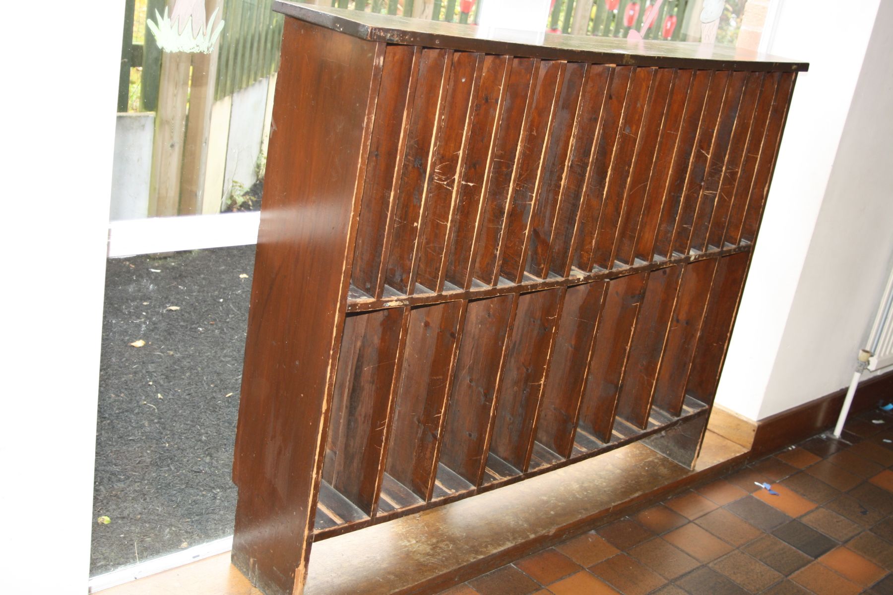 A VICTORIAN PINE MUSIC RACK, with eighteen vertical apertures over nine adapted apertures