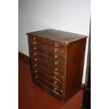 A STAINED PINE VICTORIAN COLLECTORS CABINET, with nine long drawers, turned handles (some
