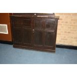 AN EDWARDIAN STAINED PINE TWO DOOR CUPBOARD, with adjustable internal shelves, 142x41x106cm high (